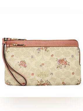 Coach Double Zip Wallet in Signature Canvas with a floral print.
